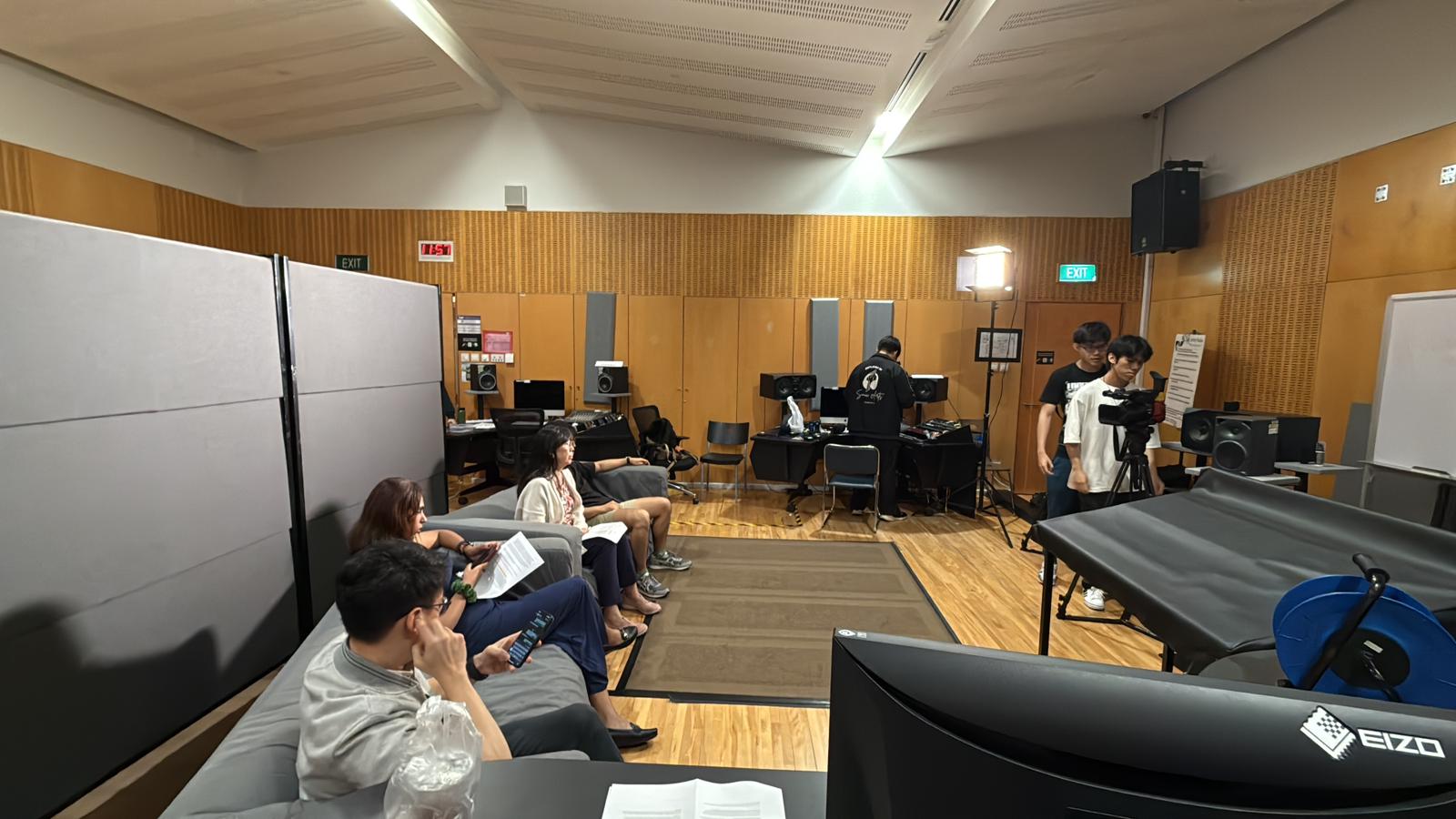 An image of the team working together before the filming and audio recording of a take on production day.