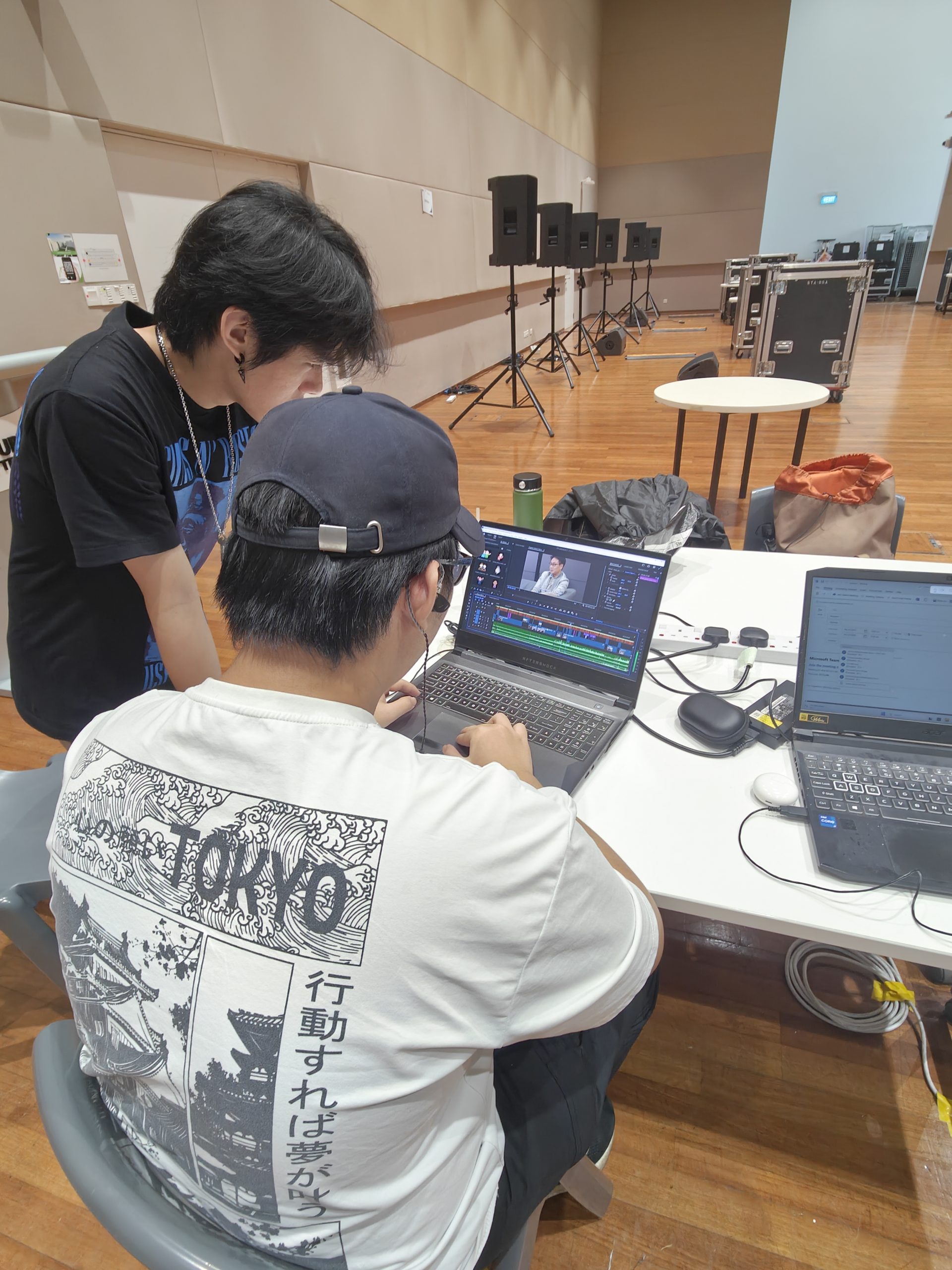 An image of a Travis providing feedback to Francis as he watches the editing session.