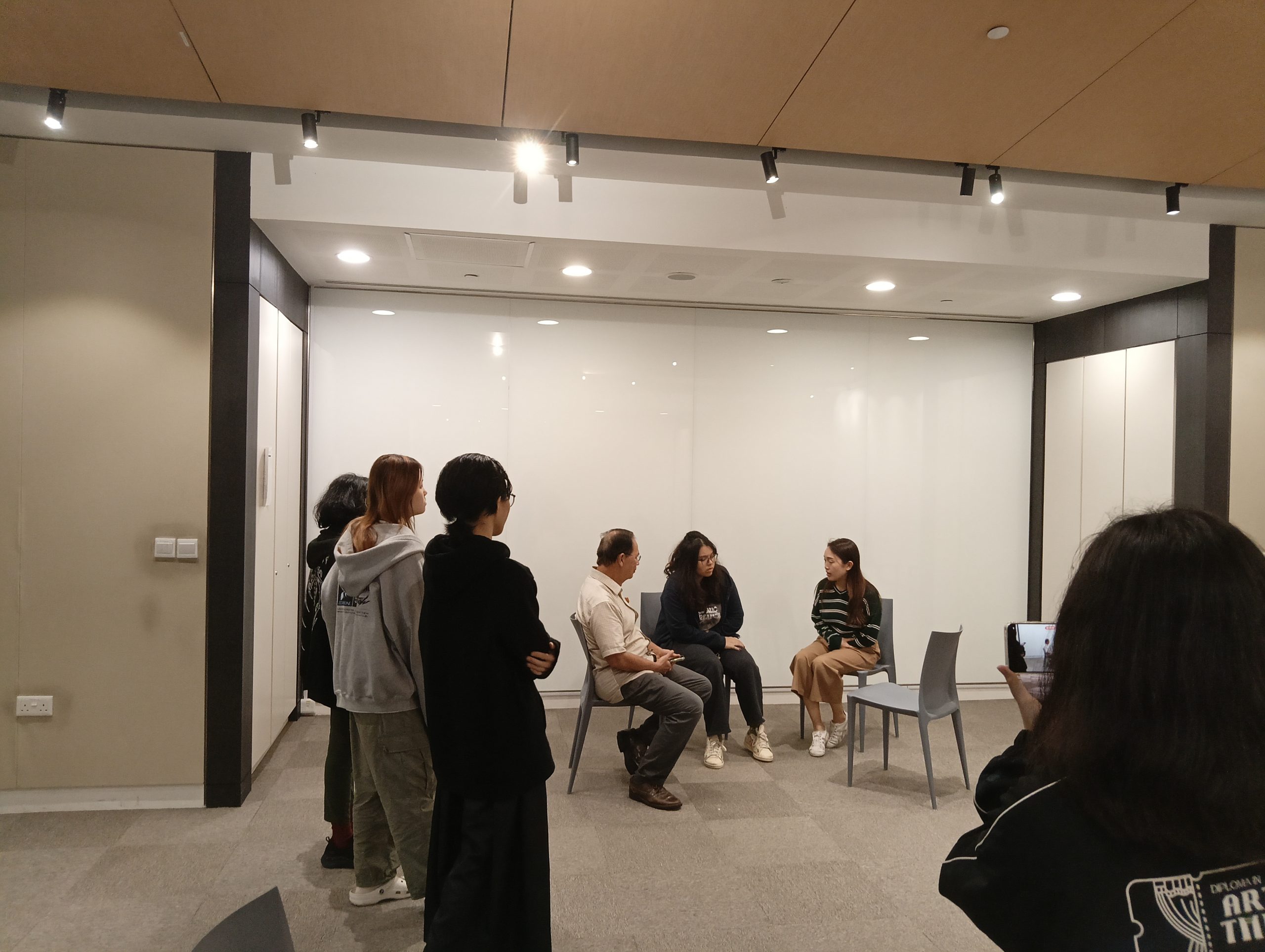 Rehearsing Scene with the docent and cast members while the team oversees the scene with the Director giving advice and steps to improve.