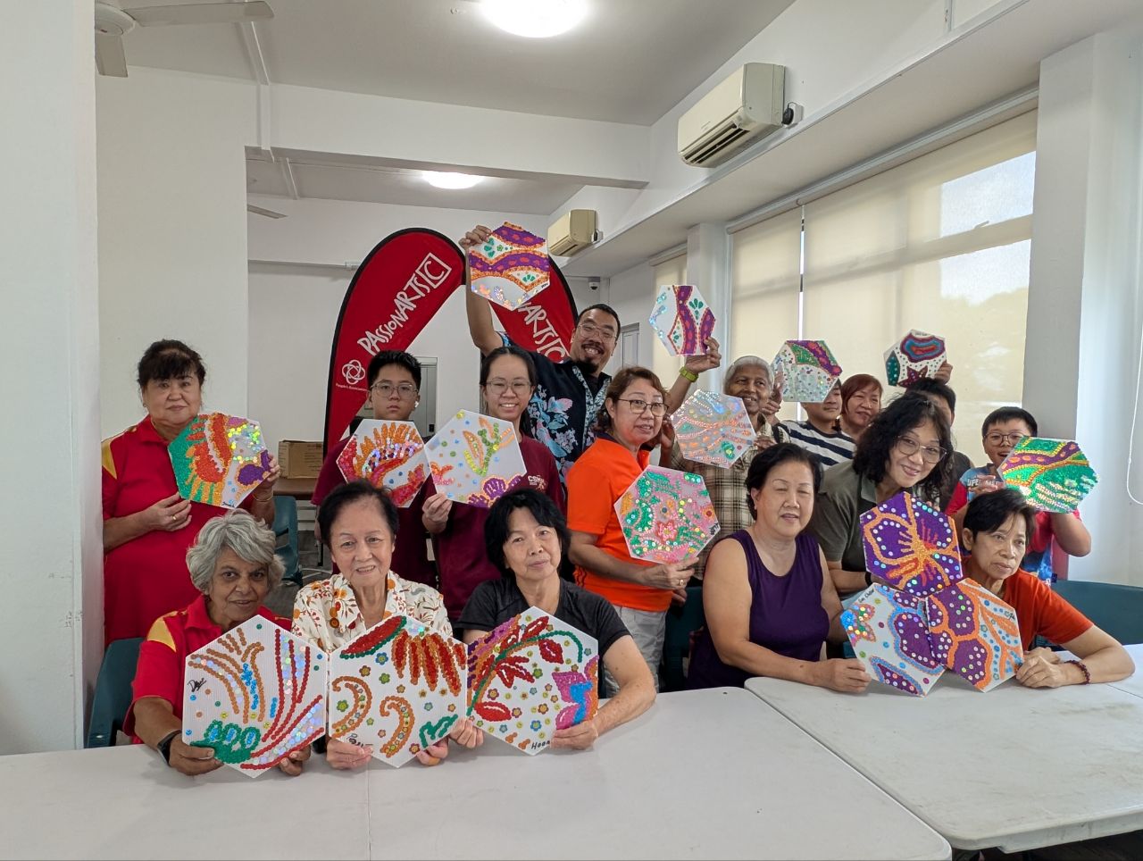 Community workshop to build float elements, teaching residents to make 'digital batik' designs using stickers.